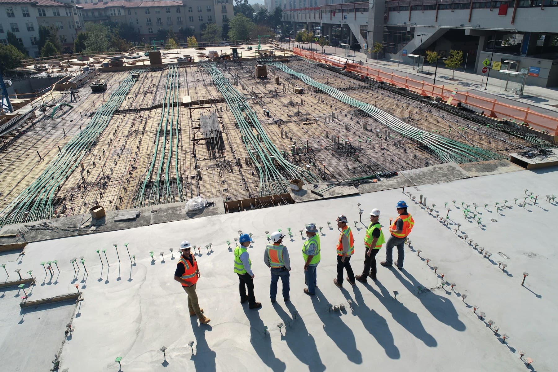 Commercial construction team reviewing active concrete work